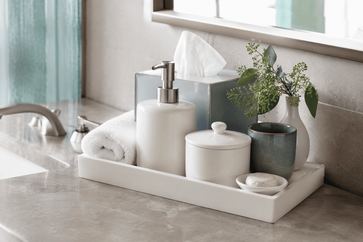 Hotel-style guest amenity tray on a vanity